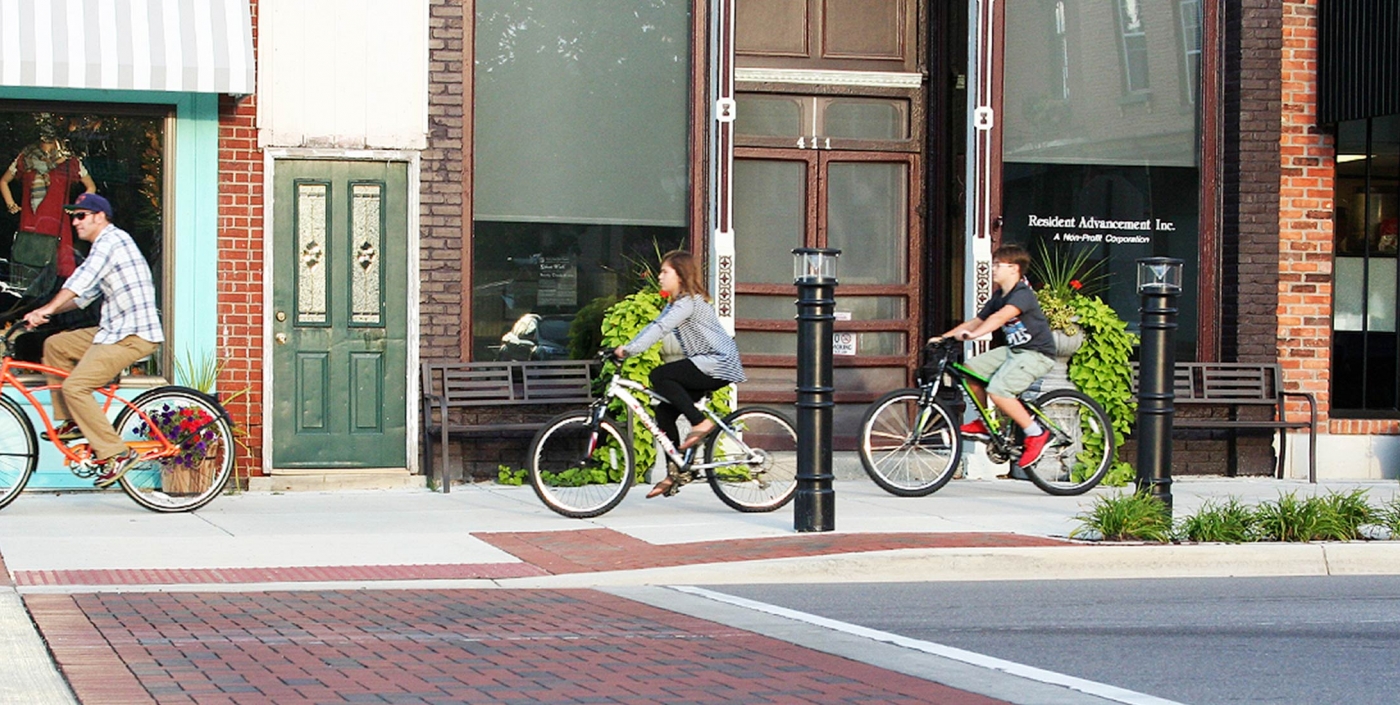 Bicyclists riding on the sidewalk in downtown Fenton.