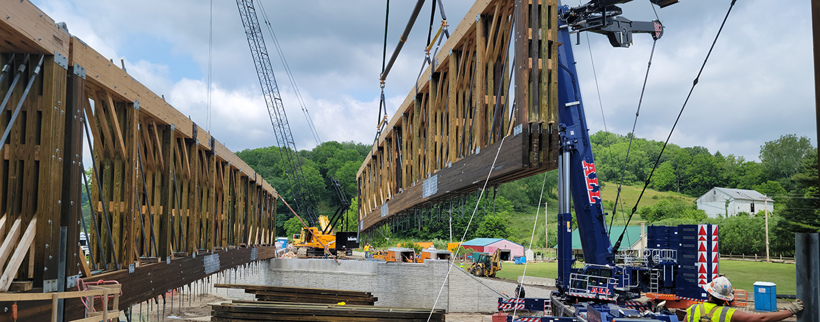 Crane moves wood structure into place during bridge construction 